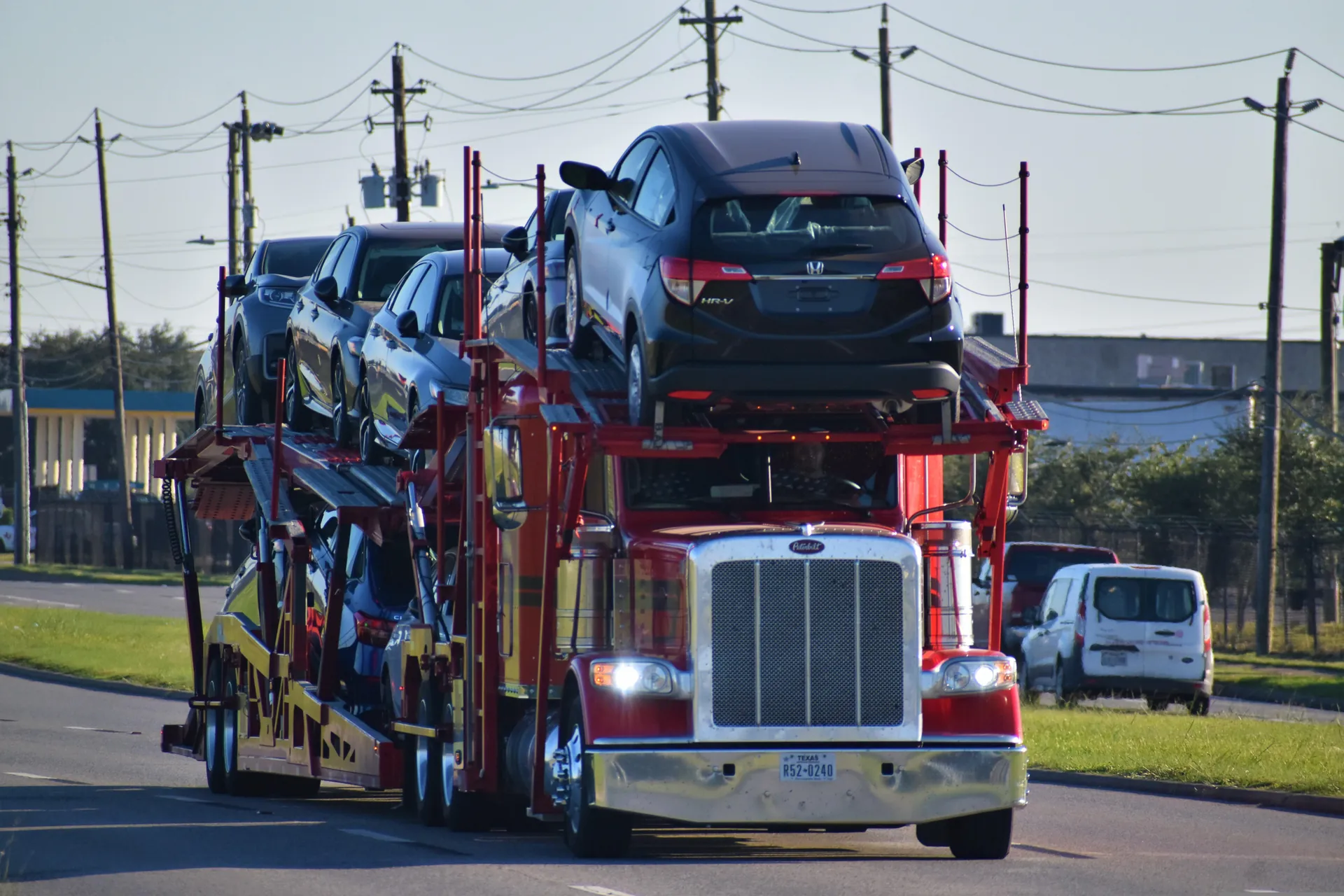 Loaded Neptune Auto Transport open car carrier on the highway